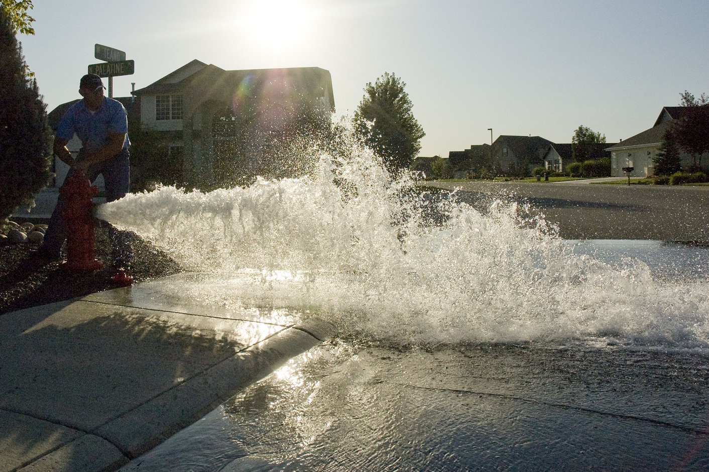 City employe flushing a water hydrant in a neighborhood