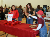 Volunteers helping a kid with a game